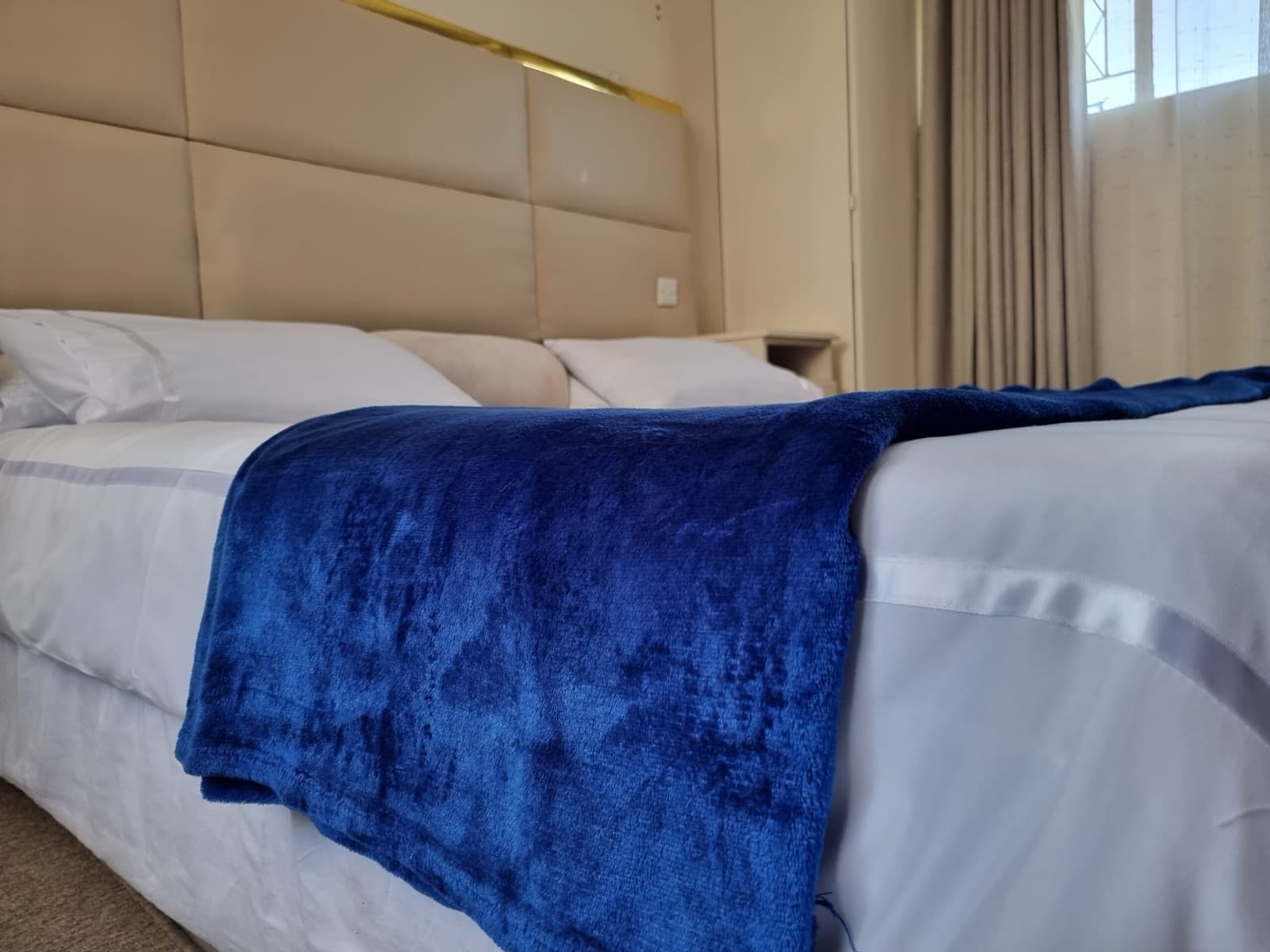 King bed with padded headboard and reading light